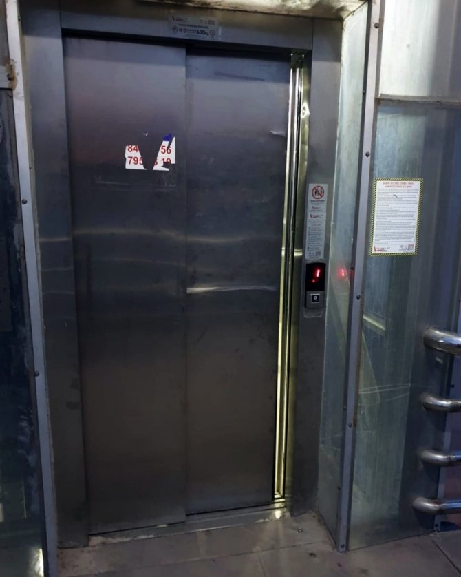 Tren yolu üst geçidindeki asansörü tekmeleyerek bozdular
